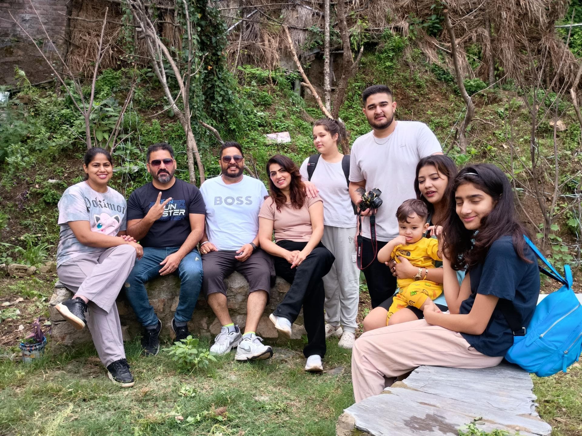 A group of guests relaxing in the garden at Mohija Homestay in Kandaghat