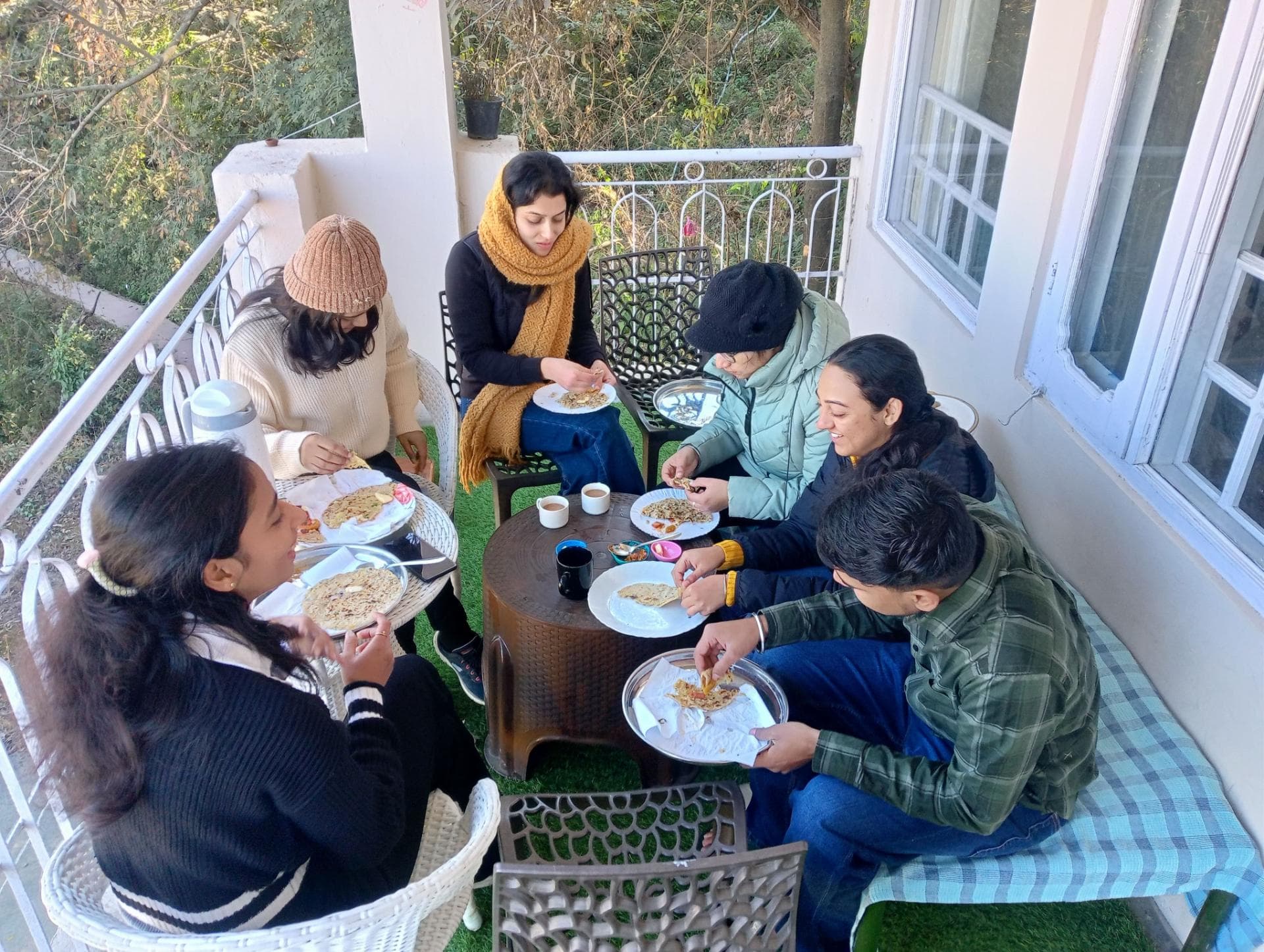 Guests enjoying a delicious breakfast on the balcony at Mohija Homestay in Kandaghat